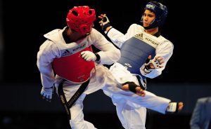 Cesar Rodriguez of Mexico (R) and Cleiver Olaizola of Venezuela face each other in a men's 54 kg category Taekwon-do combat during the 2014 Central American and Caribbean Games in Boca del Rio, state of Veracruz, Mexico, on November 15, 2014. The Games bring together nearly 8,000 athletes from 31 countries and run through November 30. AFP PHOTO/KORAL CARBALLO